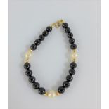14 carat gold pearl and black hardstone bracelet