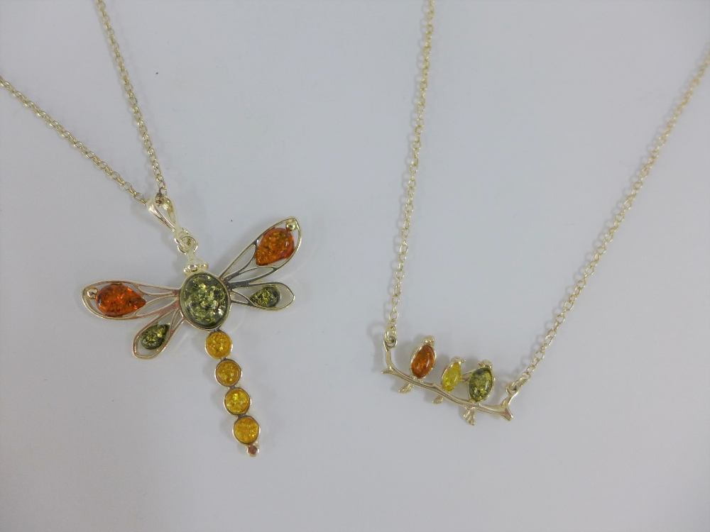 Two silver and amber pendant necklaces (2)