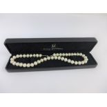 Strand of pearls with white metal clasp fitting.