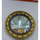Circular ebonised and gilt convex wall mirror, 65cm diameter
