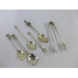 A group of silver and white metal spoons, pickle fork and sugar tongs, (6)