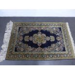 Persian silk rug, the blue ground with foliate medallion to centre and with green borders and