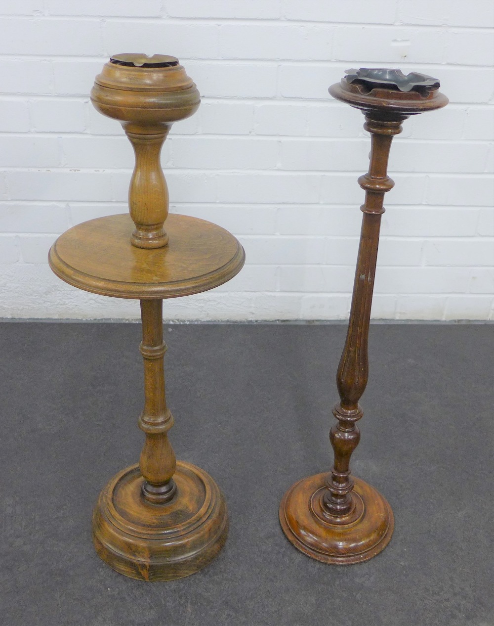 Two turned wooden ashtray stands, tallest 71cm (2)