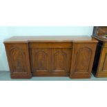 19th century flame mahogany sideboard of inverted breakfront form, with four panelled cupboard doors