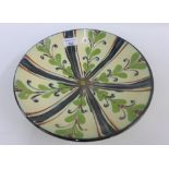 Danish studio pottery shallow dish, with flowerhead and leaf pattern, with a black edged rim,