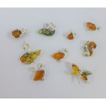 A collection of nine silver and amber pendants (9)