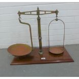 Set of late 19th / early 20th century brass scales on a mahogany plinth base, 52cm high