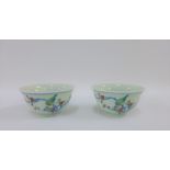 Pair of Chinese tea bowls with five colour enamels depicting birds, flowers, foliage and rock