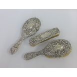 Victorian silver backed brush set and a Chester silver backed hand mirror (3)