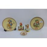 Two Goebel Hummel figures to include Just Resting and three plates, tallest 12cm, (5)