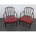 A pair of Sheraton style mahogany framed open armchairs with reeded top rail and wheat leaf
