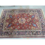 Isfahan style rug with a red field and allover foliate pattern, 140 x 220cm