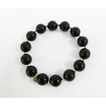 Black agate bead bracelet with gold spacers