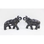 Pair of Staffordshire black glazed pottery elephants, 25cm long (2)