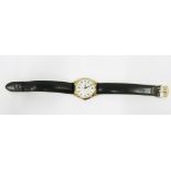 Garrard - A gentleman's 9ct gold cased wrist watch, the silvered dial with Arabic numerals,