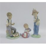 Three Nao porcelain figures of children, tallest 19cm (3)