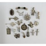 Twenty various silver charms (20)