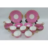 Late 19th / early 20th century pink glazed porcelain teaset, comprising twelve cups, twenty three