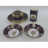 A collection of English porcelain items to include an inkwell, small vase and two saucers, all