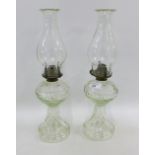 Two moulded glass oil lamps, (2)