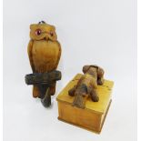 A novelty carved wooden cigarette box and an owl wall plaque, (2)