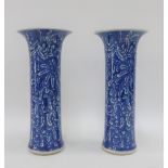 Pair of Chinese blue and white fern patterned vases, (one restored) with blue concentric marks to