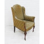 Upholstered wing armchair on mahogany and inlaid legs, with ceramic castors, 102 x 60cm