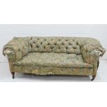 19th century Chesterfield sofa, with worn Morris style floral upholstery, on mahogany legs with