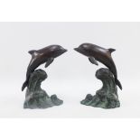 Pair of bronzed patinated metal dolphins, 16cm high (2)