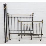 Victorian black metal single bed with brass finials and side rails.