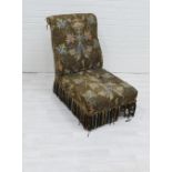 19th century chair upholstered with classical urn pattern fabric, on mahogany legs with brass caps