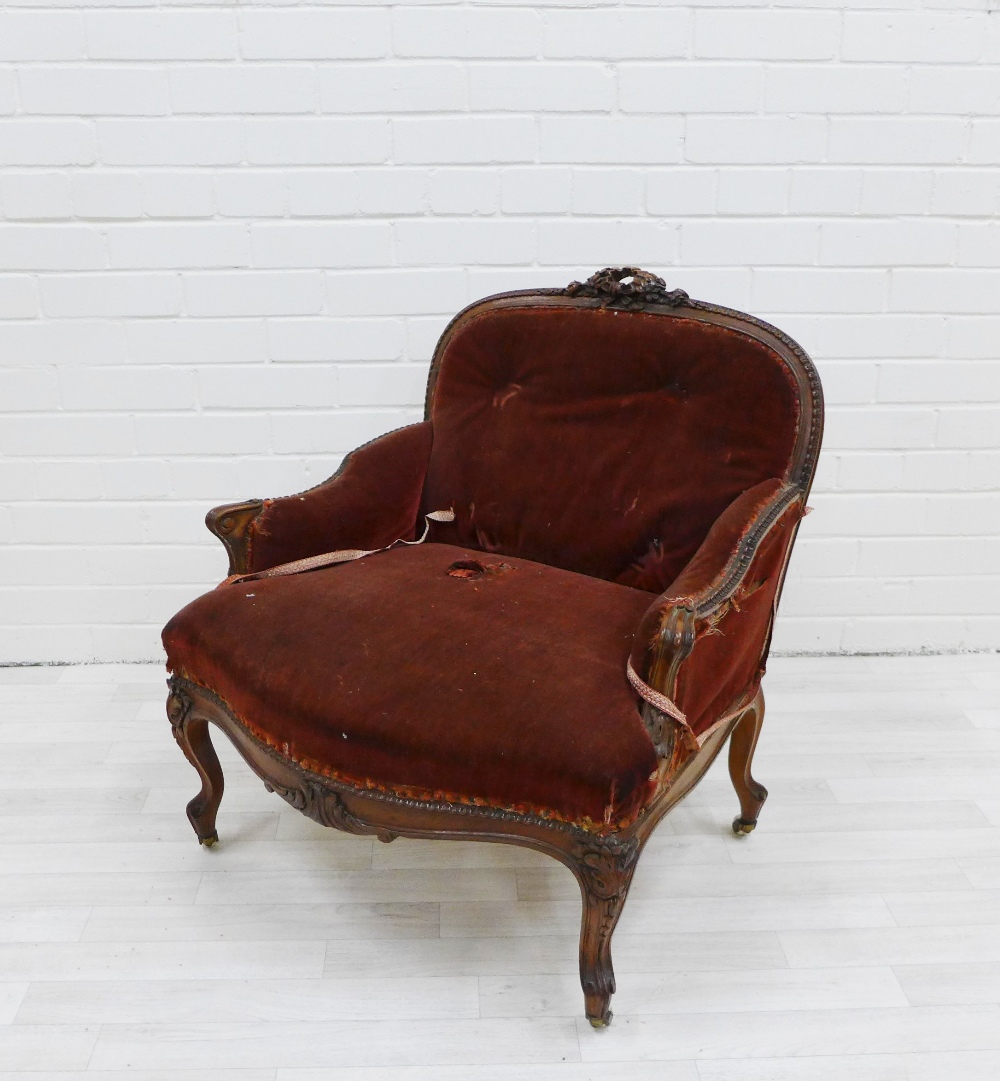 19th century mahogany framed low chair with ribbon and foliate carved top rail, upholstered back
