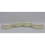 Set of four English porcelain twin handled bowls with laurel leaf gilt edged rims together with