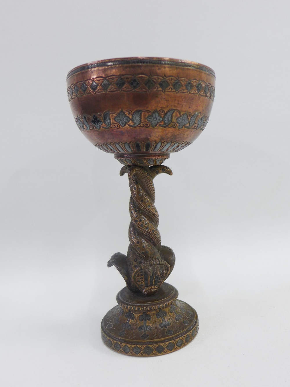 Heavy cast Persian copper and white metal inlaid goblet on a serpent stem and circular footrim, 20cm