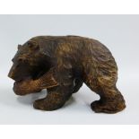 Black Forest style carved wooden bear with a fish in its mouth, 18cm long