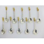 Set of ten silver teaspoons, London 1972, with gilt figural terminals, (10)