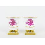 Pair of Herend porcelain pink and white floral vases, on four paw feet and square base, blue printed