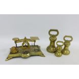 Set of brass postal scales and weights together with a set of three Victorian graduated brass