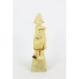 Art Nouveau hardstone figure of a Dutch or Breton girl, modelled standing on a plinth which is