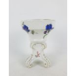 Meissen white glazed salt painted with floral sprays, raised on a tripod base, with blue crossed