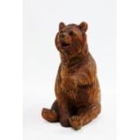 Black Forest style carved wooden bear, modelled seated, 16cm high