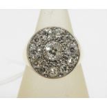 Diamond cluster ring, with central bright cut diamond in a millegrain setting with a surround of