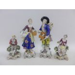 Pair of porcelain male and female figures together with a smaller pair of Gold Anchor porcelain