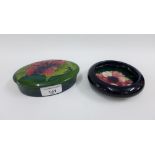 Moorcroft pottery to include a blue glazed pin dish together with oval green glazed jar and cover,