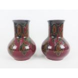 Plazuid Gouda pair of Art Pottery vases, each with red ground and dark green and yellow splash