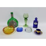 Collection of coloured glass items to include a green glass decanter and a Whitefriars type bubble