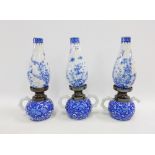 Three Japanese blue and white candlestick / lamps, with damages to handles, 32cm high (3)