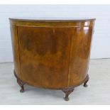 Burr walnut bow front cabinet with central shelves flanked by cupboard doors, on carved cabriole