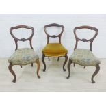 A set of three mahogany balloon back chairs, two with tapestry upholstered seat an the other with