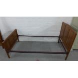 Pair of Gordon Russell three fielded panel walnut beds, on chamfered supports, complete with side